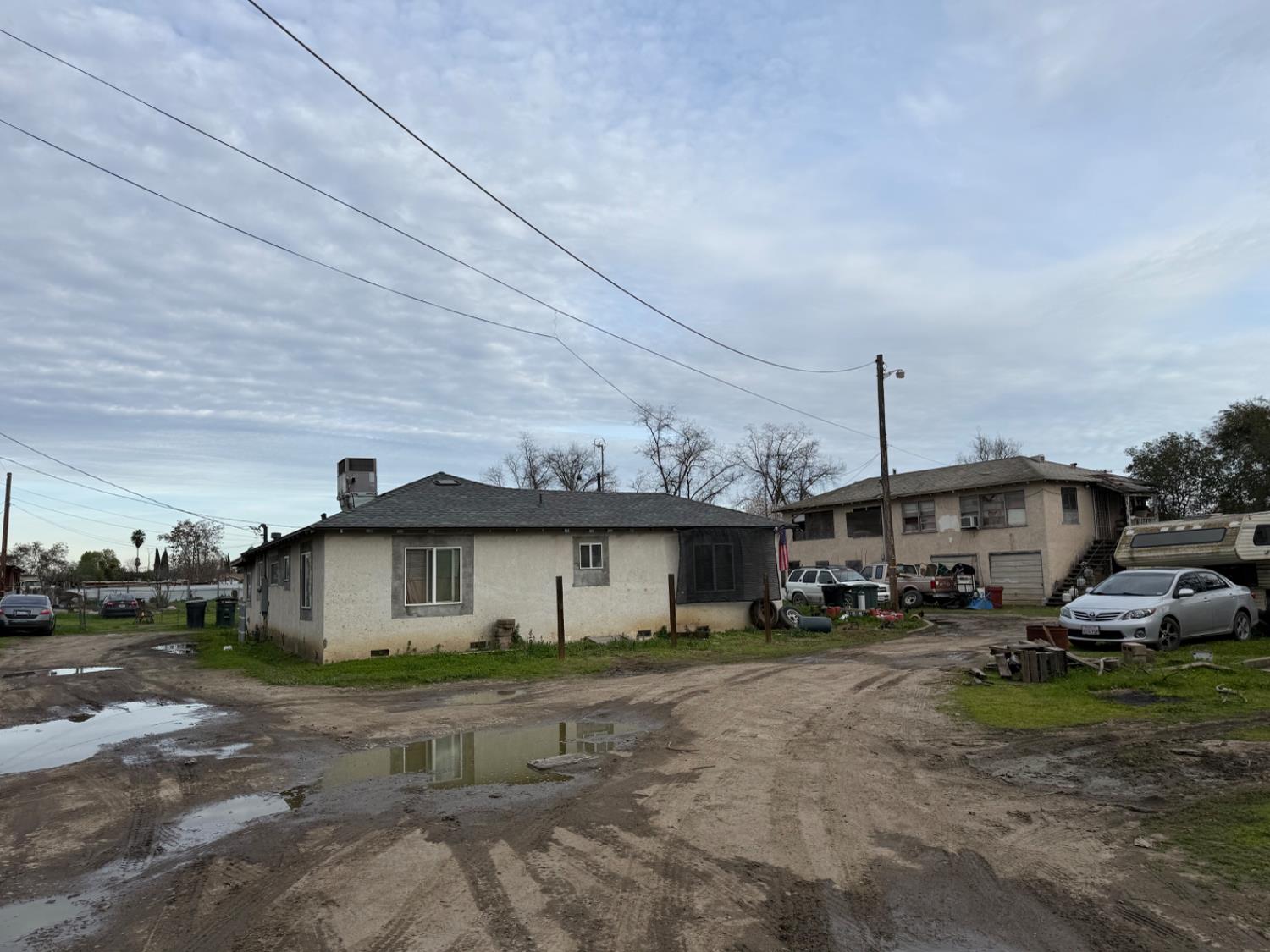 a front view of a house with a garden and parking space