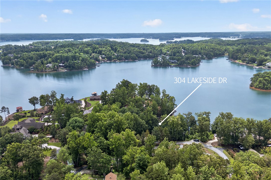 304 Lakeside Drive Seneca, SC 29672 - Photo 47 of 49 An aerial perspective reveals a serene lake dotted with islands, surrounded by lush, mature trees.