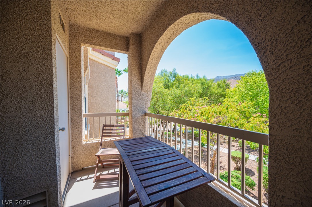 10550 West Alexander Road, Unit 2014 Las Vegas, NV 89129 - Photo 7 of 35 Enjoy verdant garden vistas and distant mountains from this private arched balcony.
