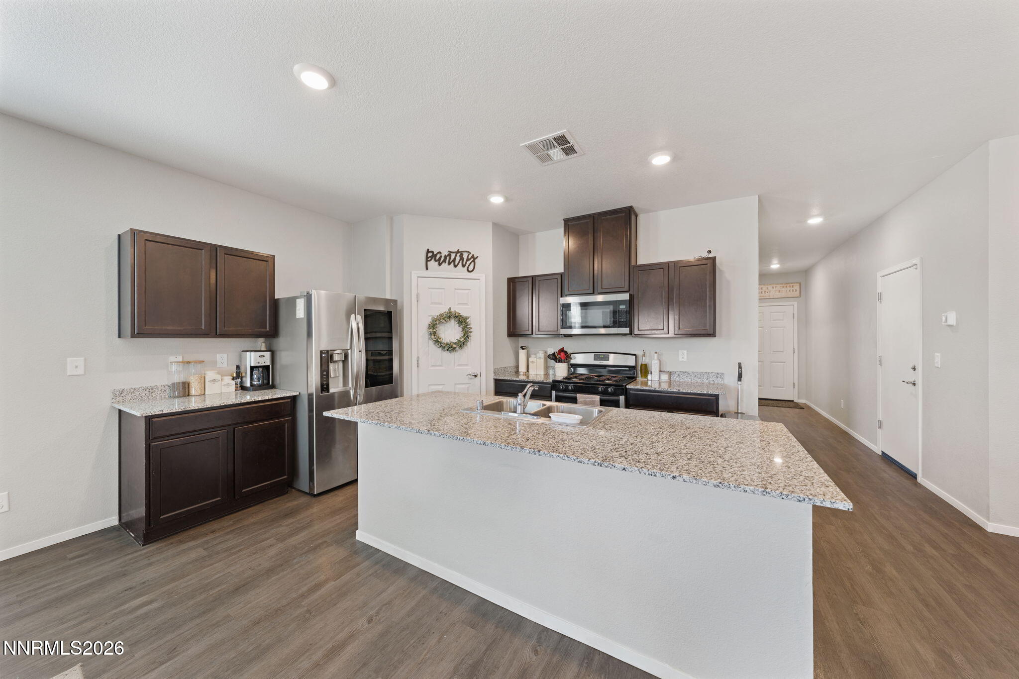 9708 Sea Glass Drive Reno, NV 89506 - Photo 31 of 51 a large kitchen with kitchen island granite countertop a stove top oven a sink a counter space and cabinets