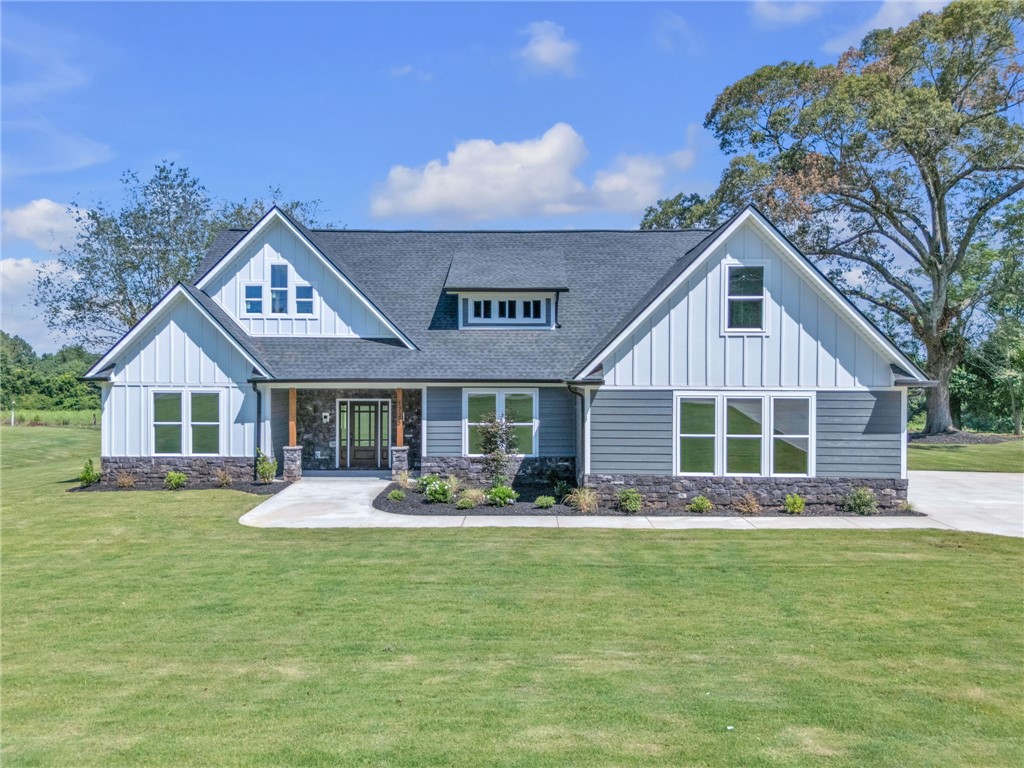 1725 Harris Bridge Road Anderson, SC 29621 - Photo 1 of 33 A gracefully designed facade presents an inviting entry with mixed siding and natural stone accents.
