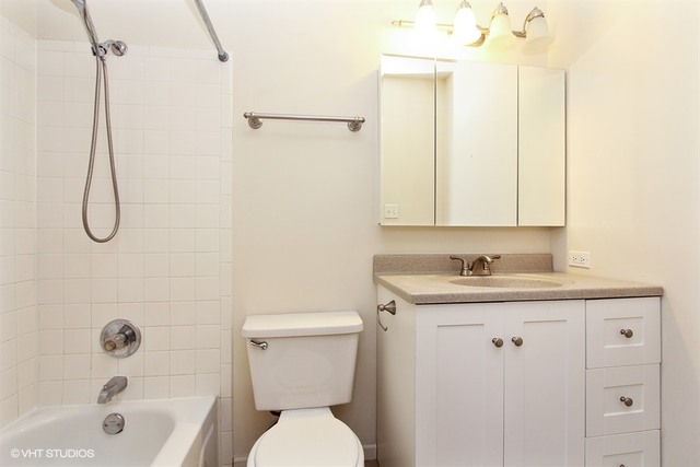 2028 North Rand Road, Unit 201 Palatine, IL 60074 - Photo 6 of 12 a bathroom with a granite countertop sink a toilet and shower