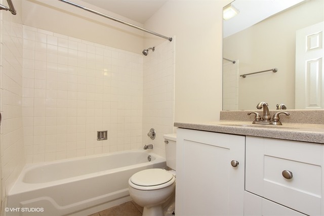 2028 North Rand Road, Unit 201 Palatine, IL 60074 - Photo 8 of 12 a bathroom with a granite countertop sink a toilet and shower