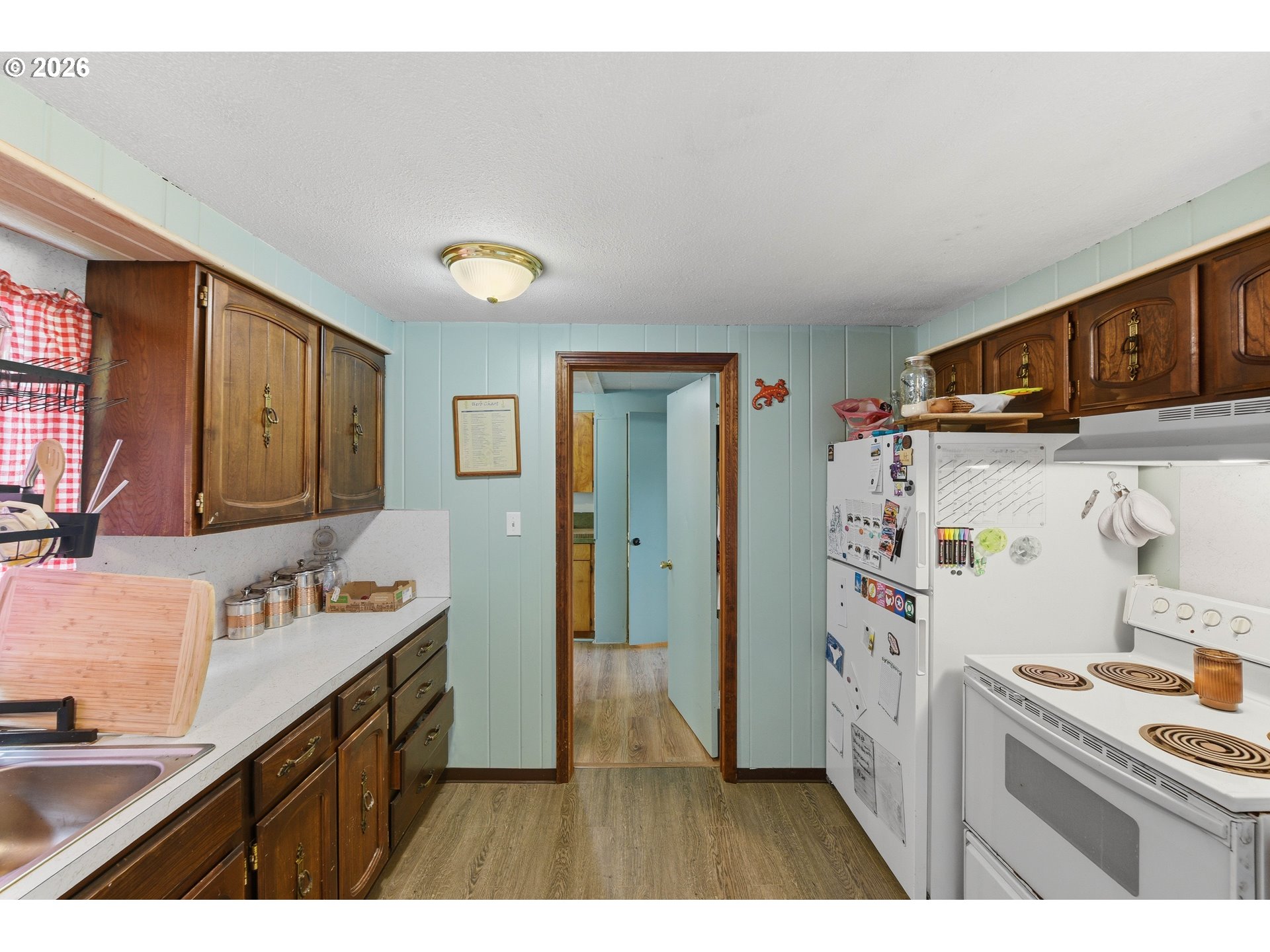 1955 Maple Street North Bend, OR 97459 - Photo 16 of 48 a kitchen with refrigerator and cabinets