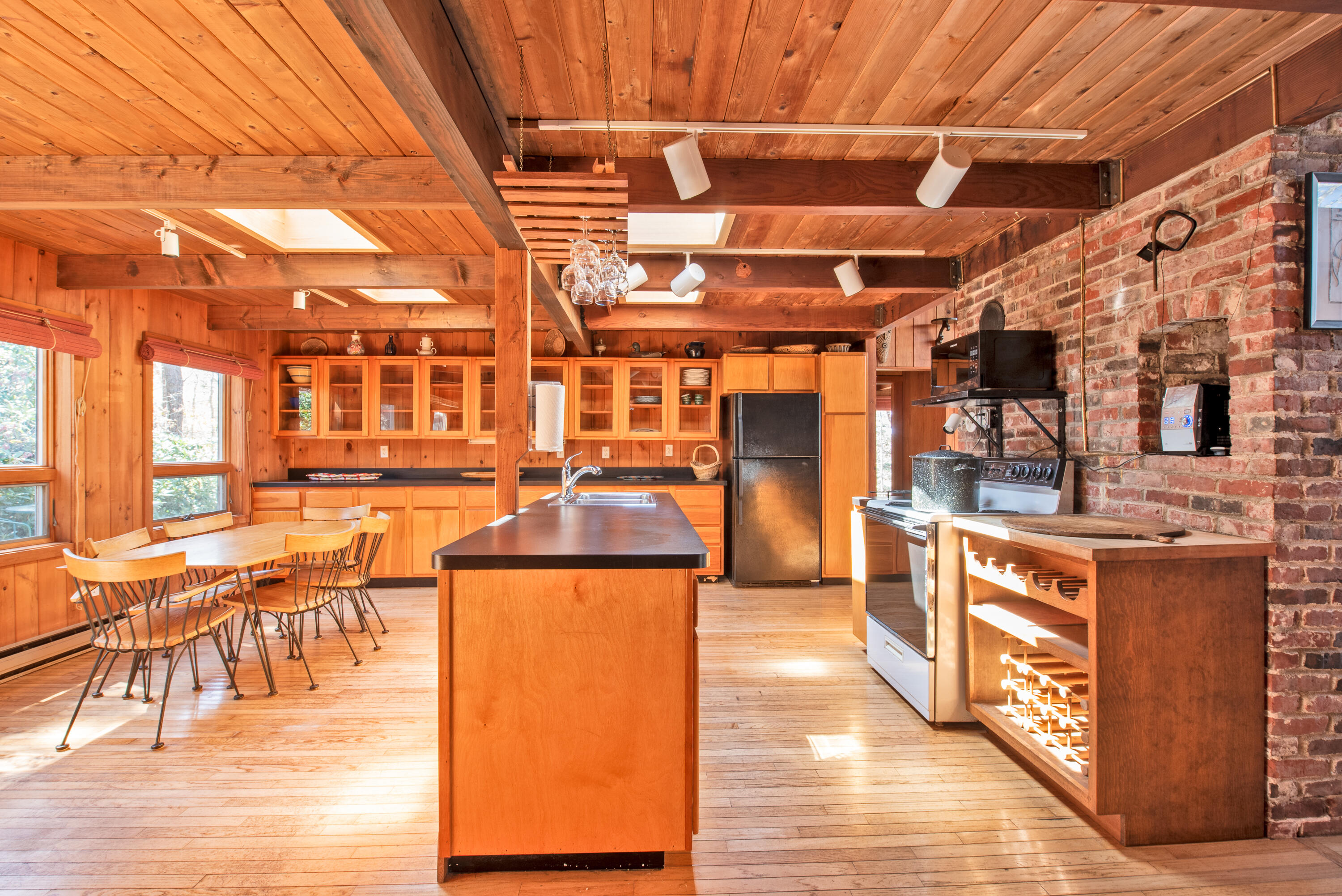 1162 Browns Neck Road Wellfleet, MA 02667 - Photo 16 of 30 a kitchen with stainless steel appliances wooden cabinets a sink and a stove