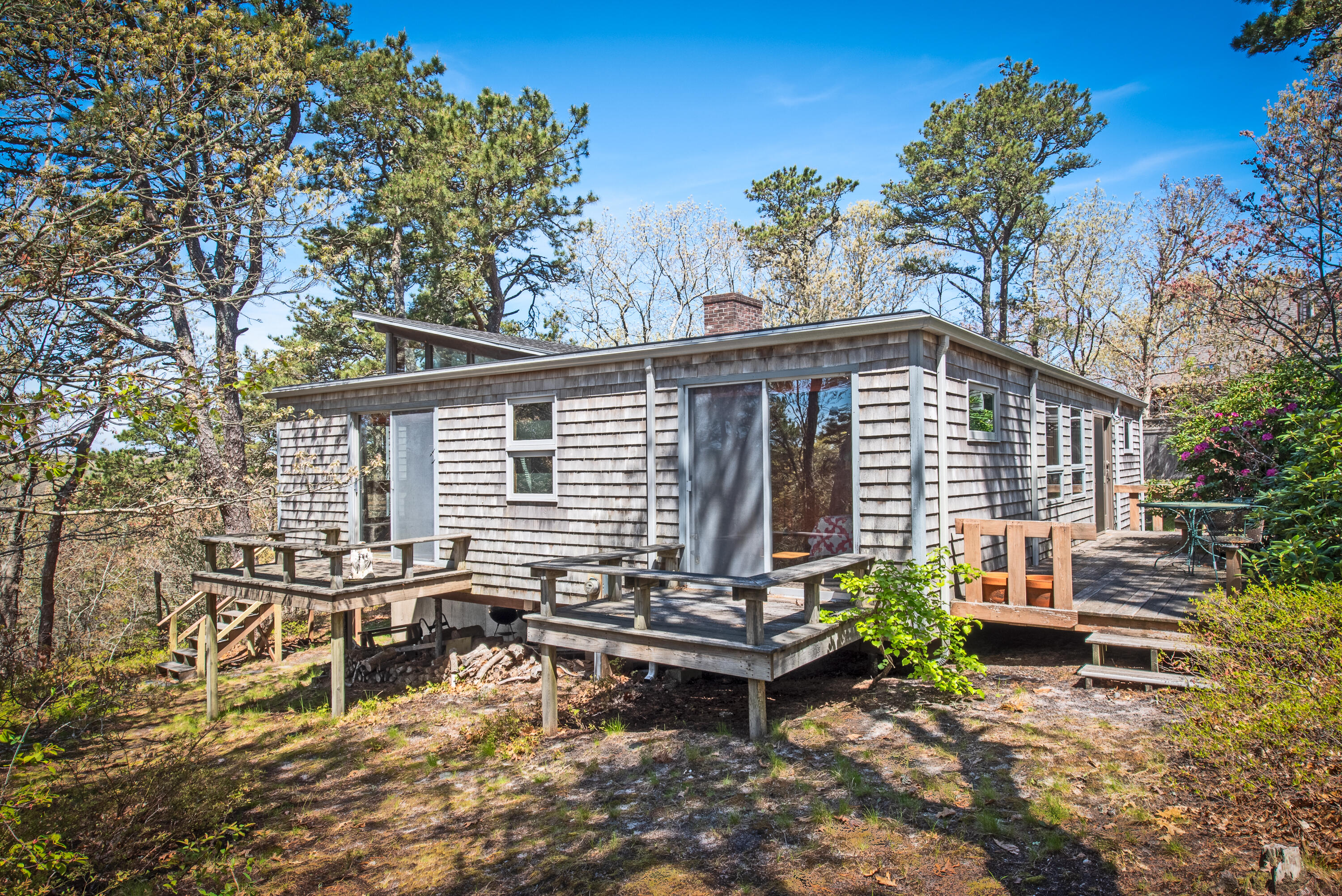 1162 Browns Neck Road Wellfleet, MA 02667 - Photo 4 of 30 a backyard of a house with table and chairs