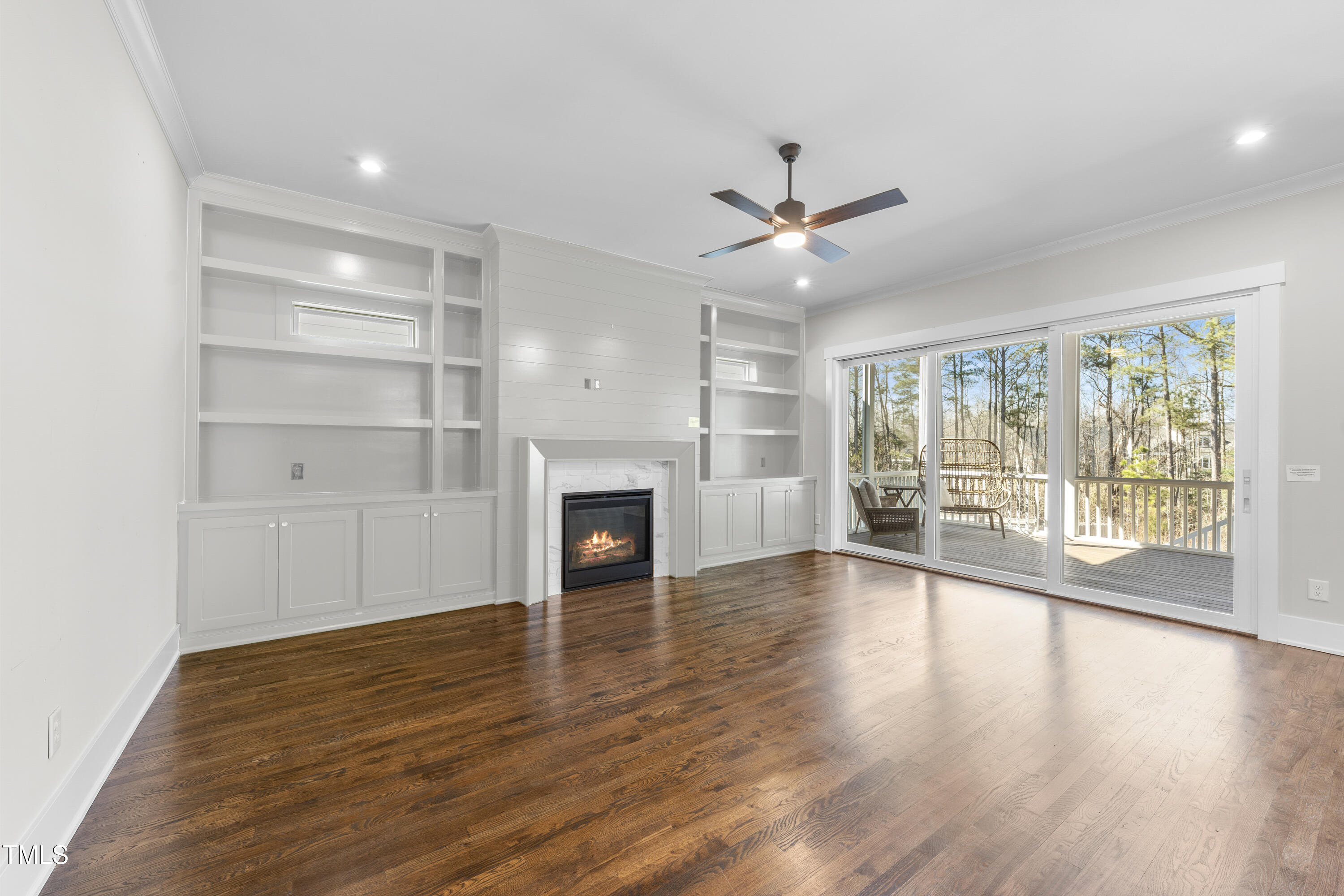 729 Daniel Rdg Road Wendell, NC 27591 - Photo 10 of 57 a view of empty room with wooden floor and fireplace