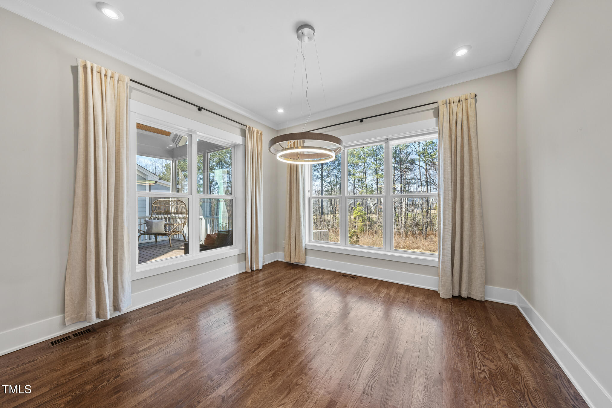 729 Daniel Rdg Road Wendell, NC 27591 - Photo 12 of 57 a view of an empty room with wooden floor and a window
