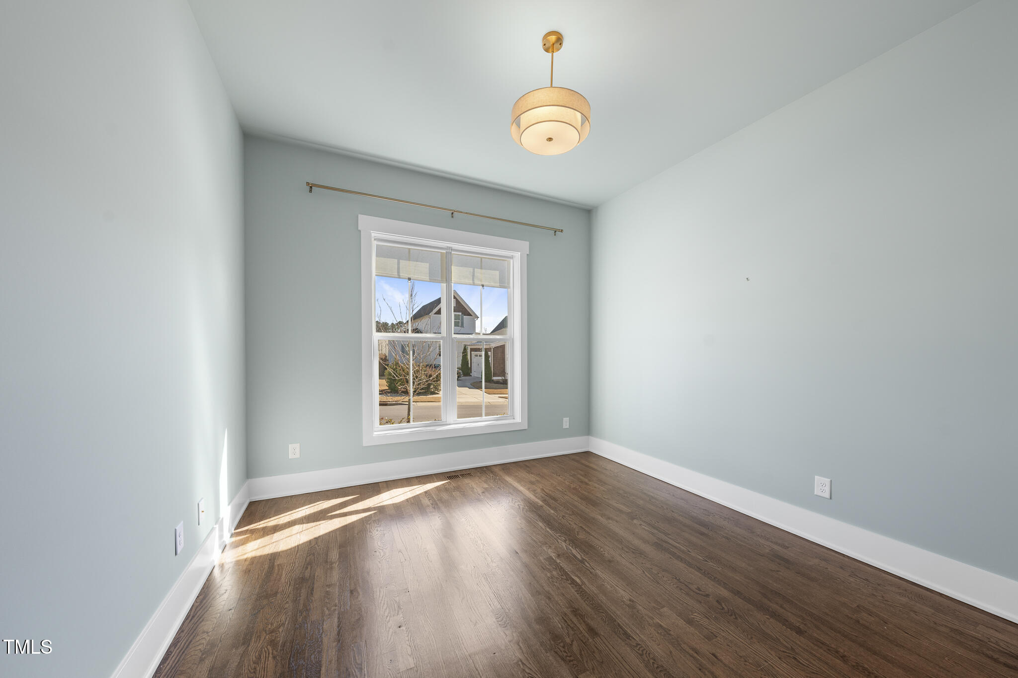 729 Daniel Rdg Road Wendell, NC 27591 - Photo 17 of 57 an empty room with wooden floor and windows