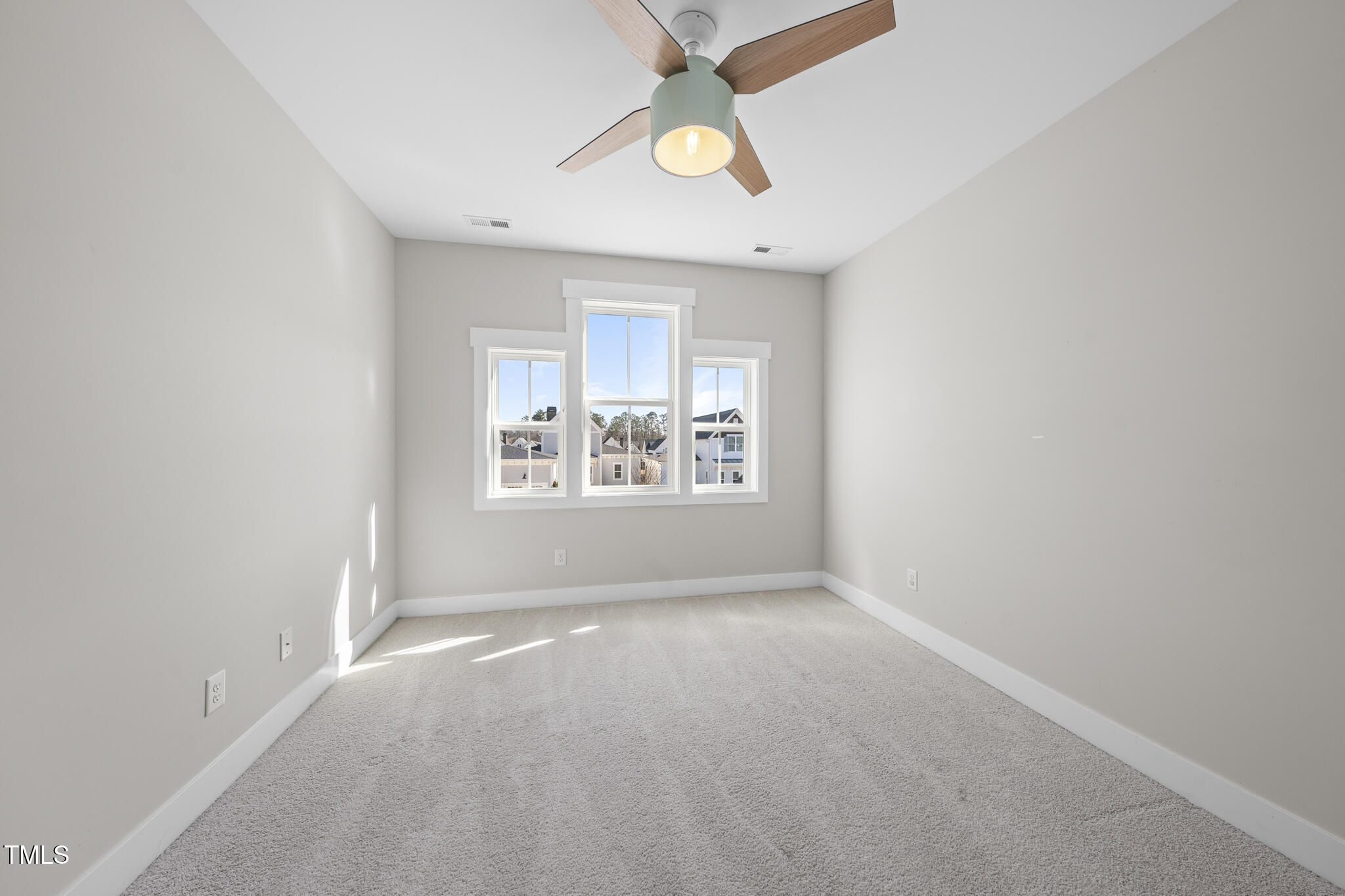 729 Daniel Rdg Road Wendell, NC 27591 - Photo 29 of 57 an empty room with a window and a fan