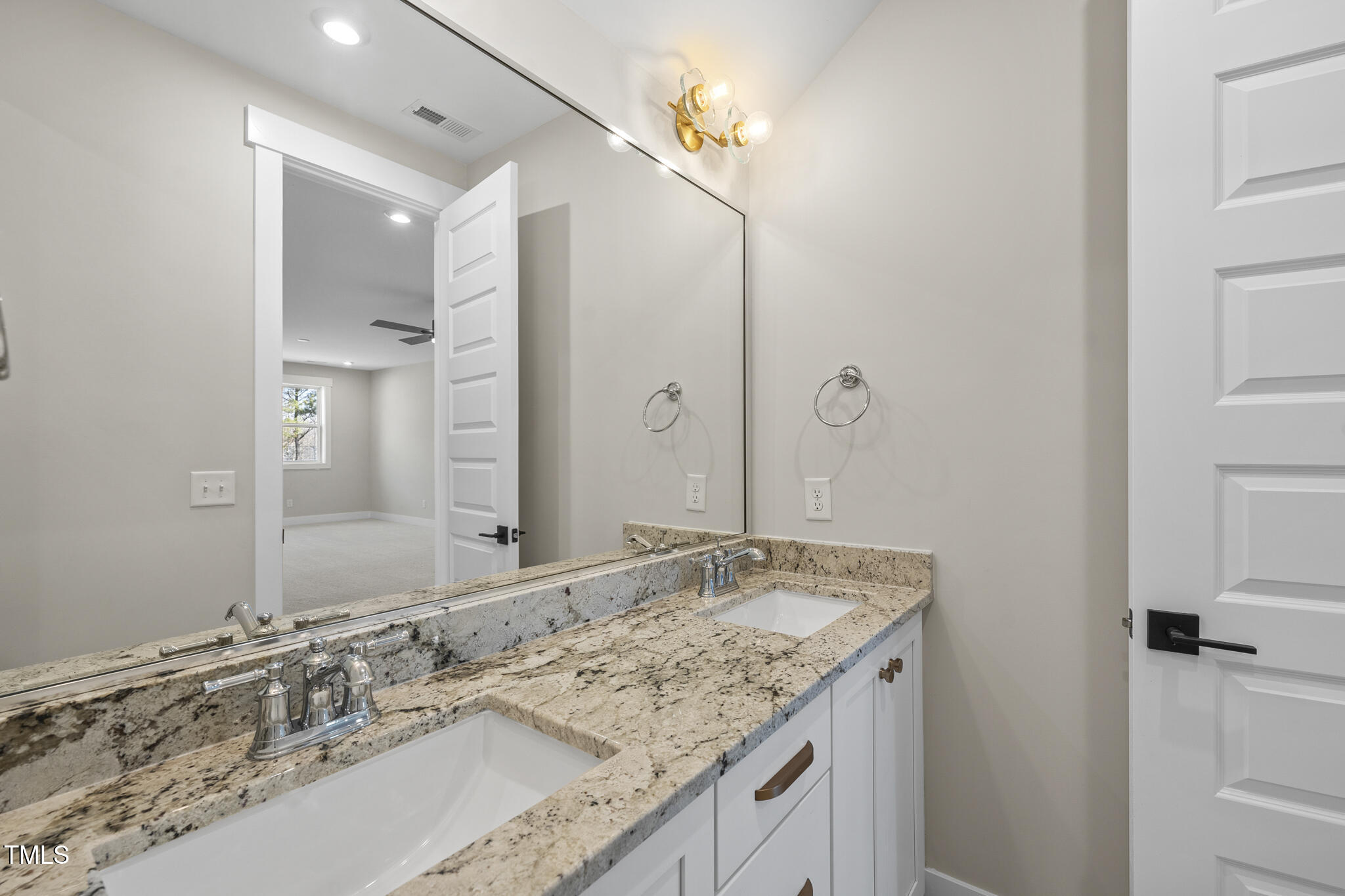 729 Daniel Rdg Road Wendell, NC 27591 - Photo 33 of 57 a bathroom with a granite countertop double vanity sink and a mirror