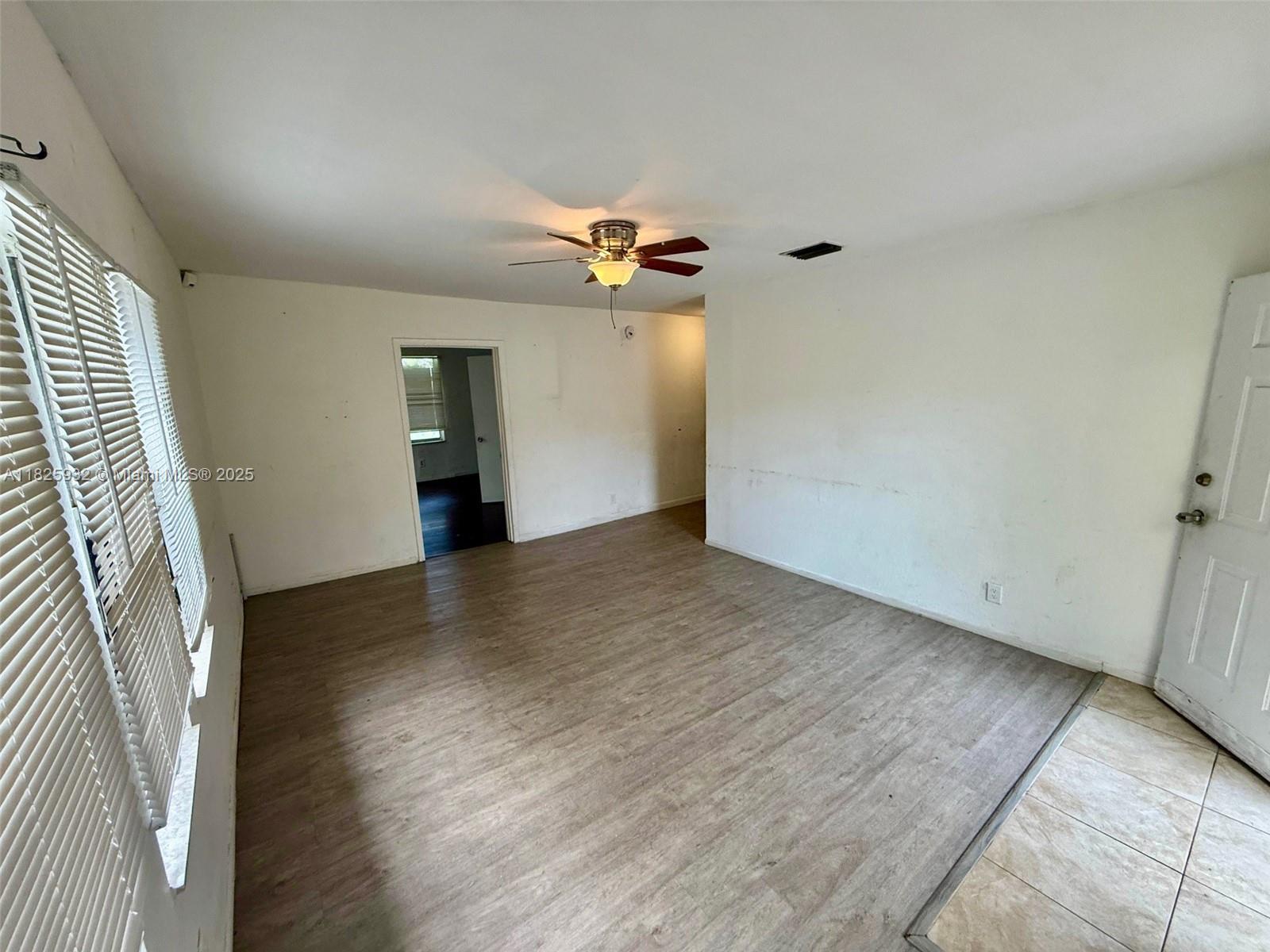 706 9th Street, Unit 2 West Palm Beach, FL 33401 - Photo 2 of 9 wooden floor in an empty room with a window