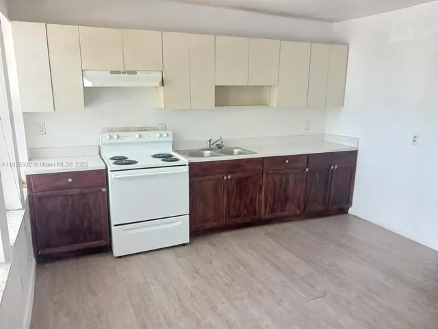 a kitchen with a cabinets and white stove