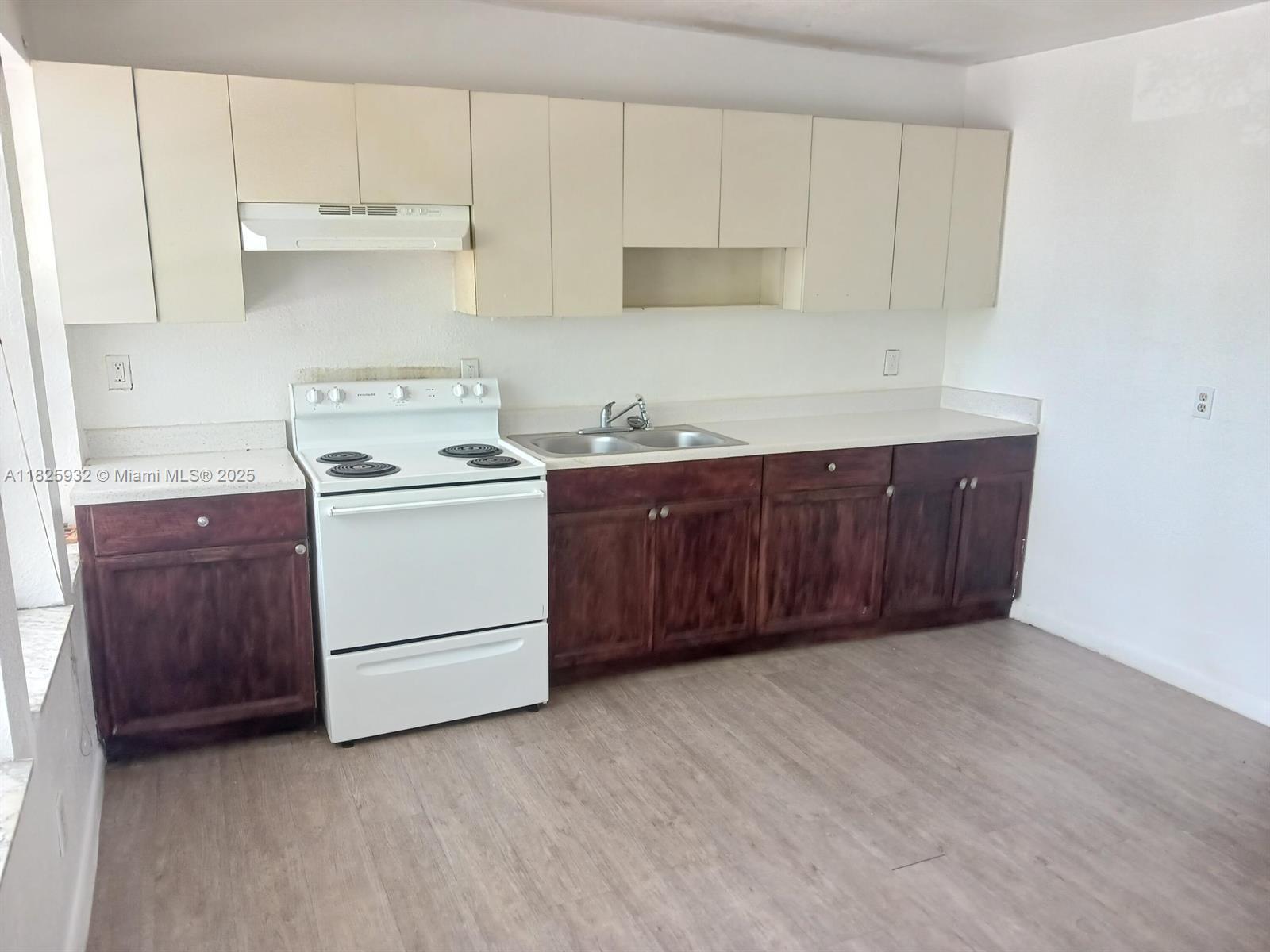 706 9th Street, Unit 2 West Palm Beach, FL 33401 - Photo 3 of 9 a kitchen with a cabinets and white stove