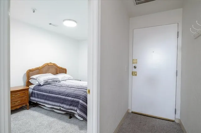 a bedroom with a bed and a lamp