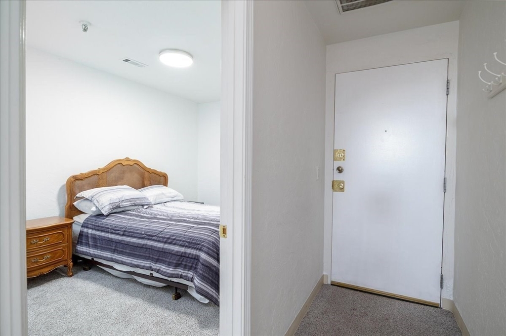 531 Main Street, Unit 503 Worcester, MA 01608 - Photo 14 of 21 a bedroom with a bed and a lamp