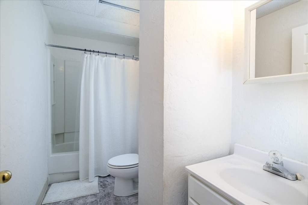 531 Main Street, Unit 503 Worcester, MA 01608 - Photo 18 of 21 a bathroom with a sink a toilet and shower