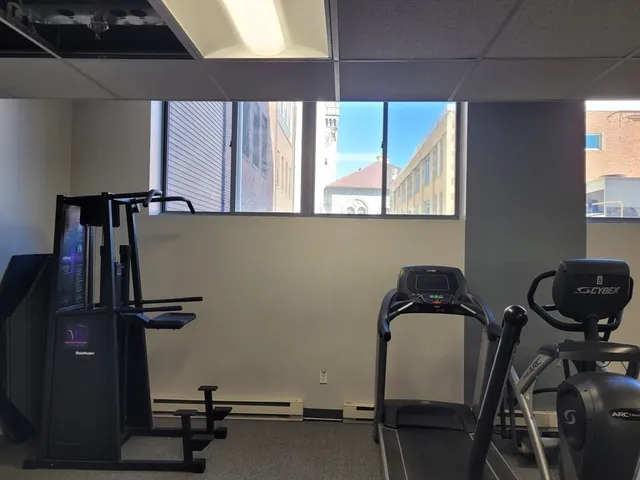 a view of workspace with mirror and window