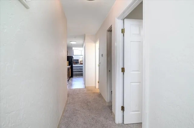 a view of a hallway with wooden shelves