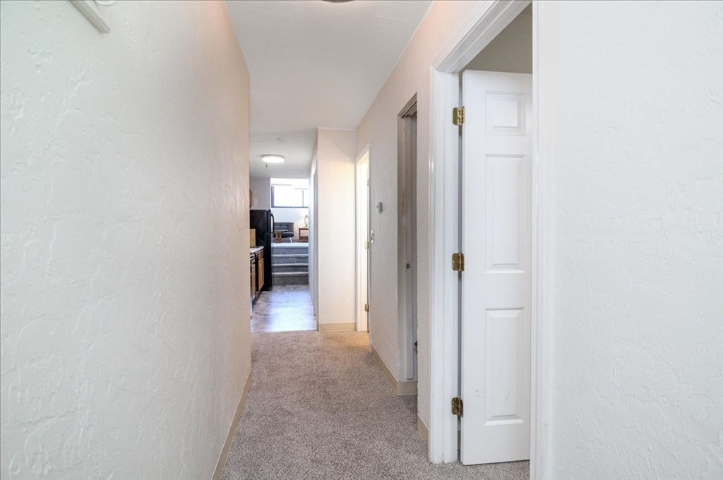 531 Main Street, Unit 503 Worcester, MA 01608 - Photo 10 of 21 a view of a hallway with wooden shelves
