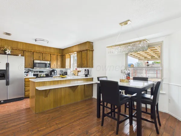 a kitchen with a refrigerator a sink and cabinets