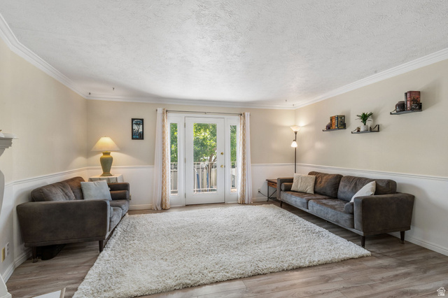 553 North 200 West Bountiful, UT 84010 - Photo 1 of 26 Living room with light wood-style flooring, a textured ceiling, and ornamental molding