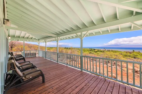 a view of a patio with couches table and chairs and potted plants