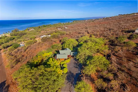 an aerial view of a house with a yard