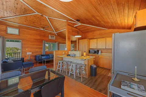 a view of a porch with wooden floor and a yard