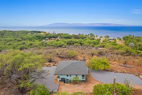 an aerial view of a house with a yard