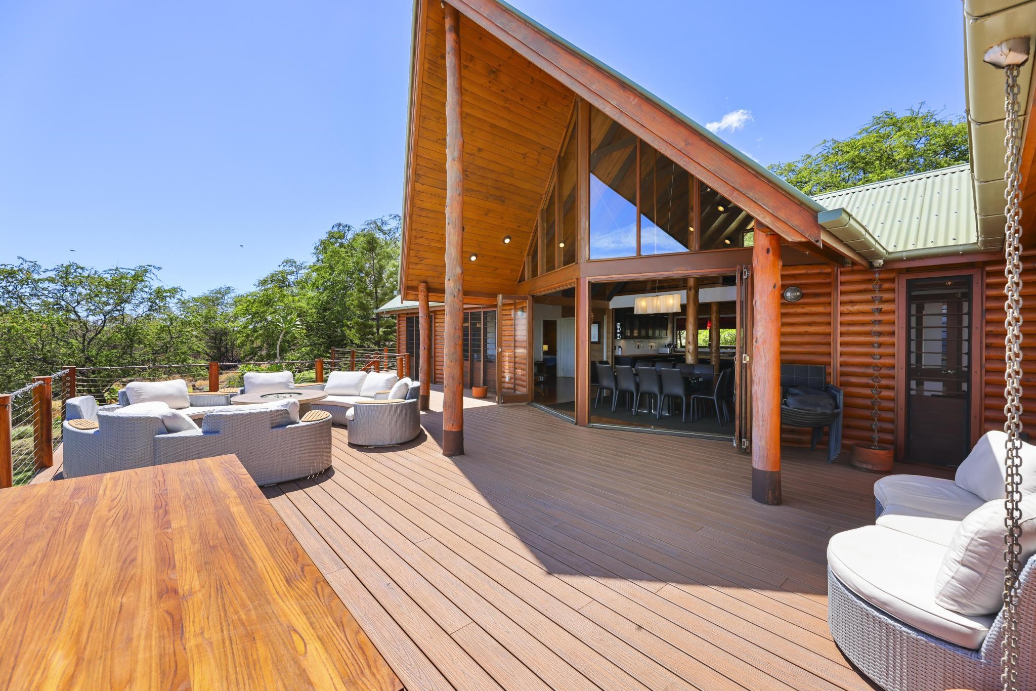 122 Ulua Road Kaunakakai, HI 96748 - Photo 7 of 48 a view of a patio with couches and table and chairs with wooden floor and fence