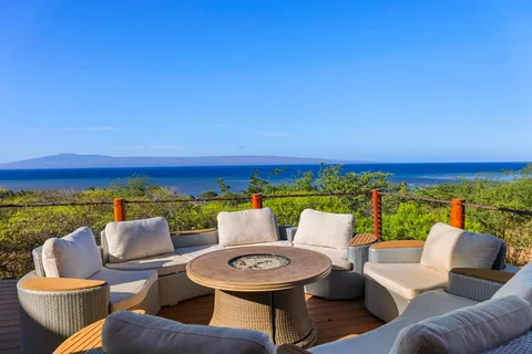 a outdoor living room with furniture and a floor to ceiling window