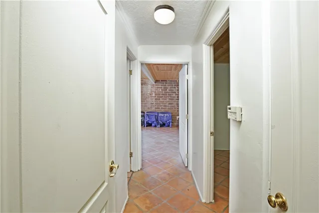 a large white bed sitting in a bedroom next to a window