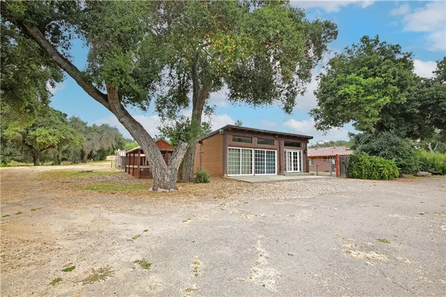 a front view of a house with a yard and a garage
