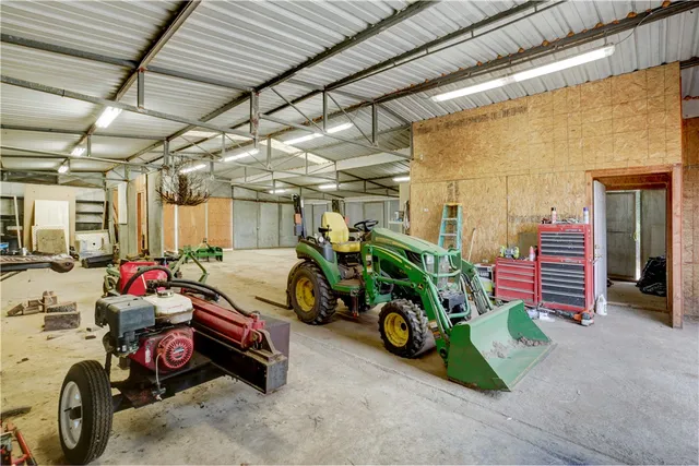 a view of a house with a floor to ceiling window and brick wall
