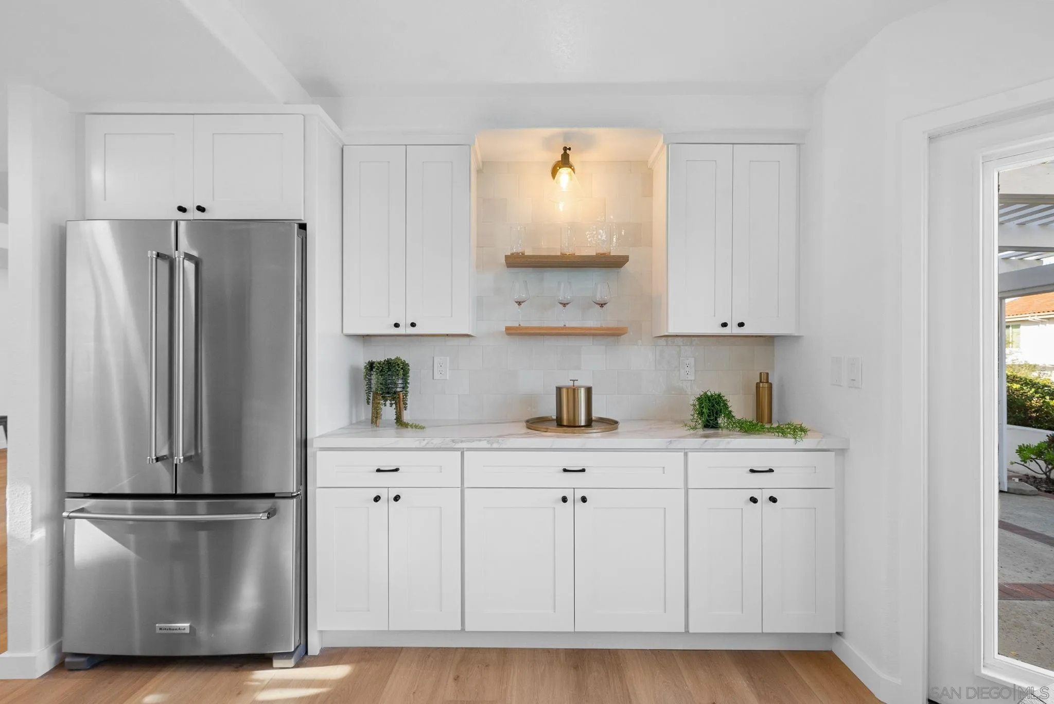 4975 Delos Way Oceanside, CA 92056 - Photo 11 of 31 a kitchen with stainless steel appliances white cabinets and a refrigerator