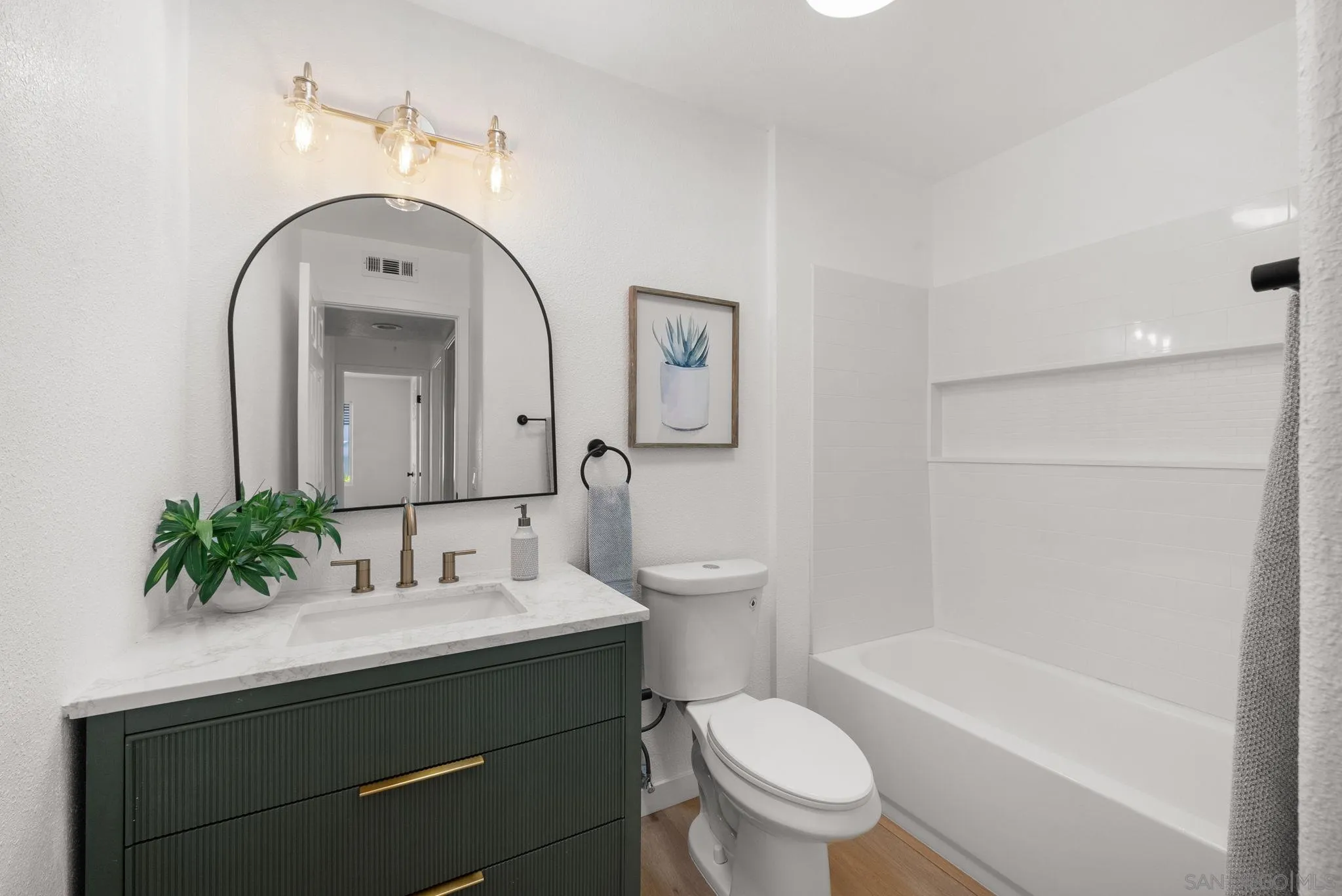 4975 Delos Way Oceanside, CA 92056 - Photo 14 of 31 a bathroom with a sink a toilet and a tub