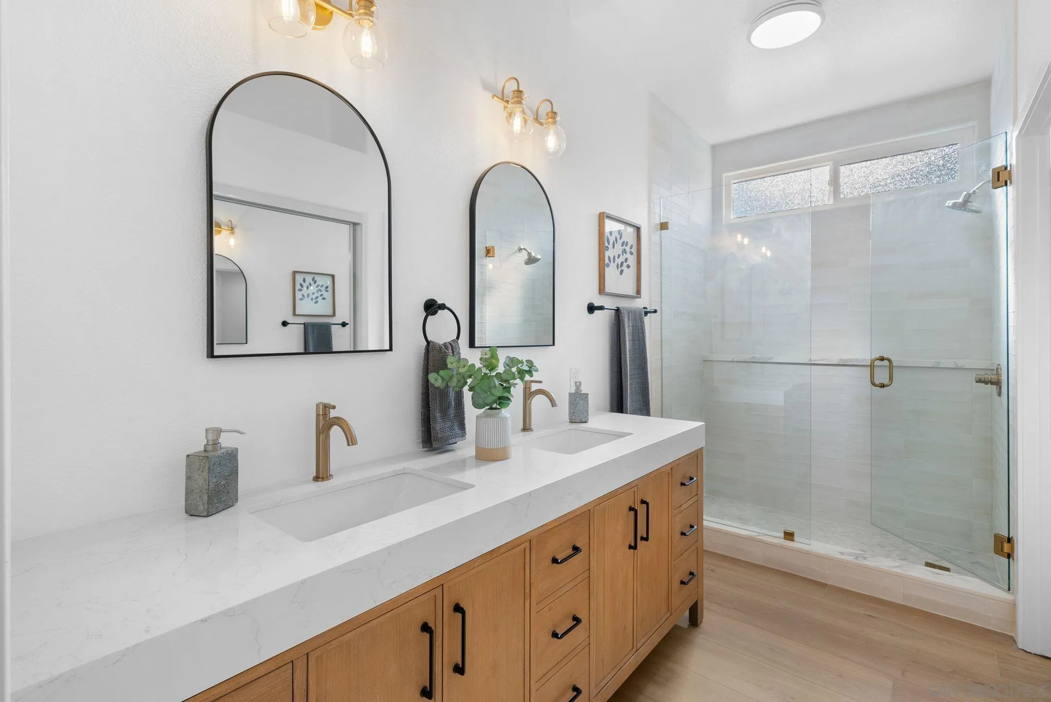4975 Delos Way Oceanside, CA 92056 - Photo 21 of 31 a bathroom with a double vanity sink mirror and shower
