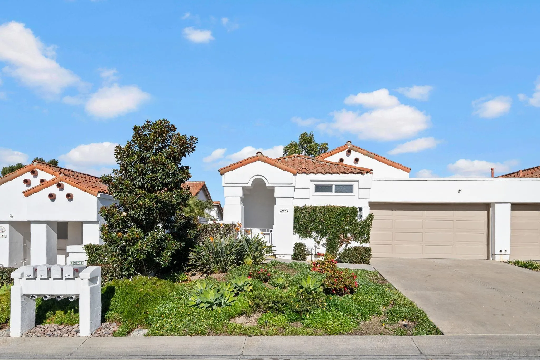 4975 Delos Way Oceanside, CA 92056 - Photo 31 of 31 a front view of a house with a yard and potted plants