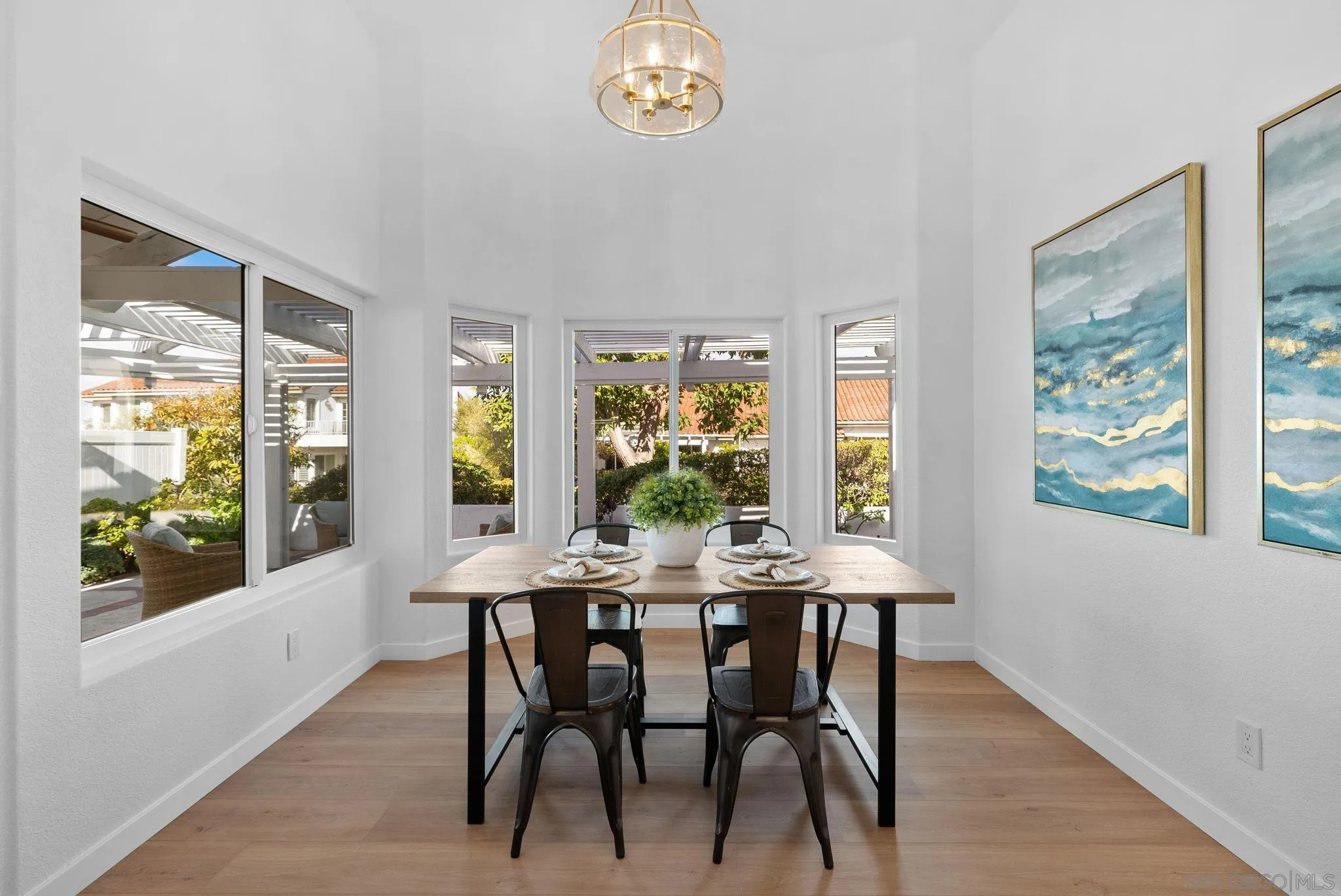 4975 Delos Way Oceanside, CA 92056 - Photo 5 of 31 a view of a dining room with furniture a chandelier and wooden floor