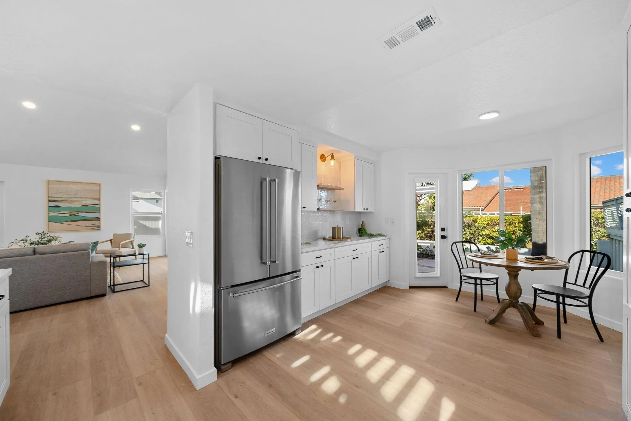 4975 Delos Way Oceanside, CA 92056 - Photo 9 of 31 a kitchen with refrigerator and furniture