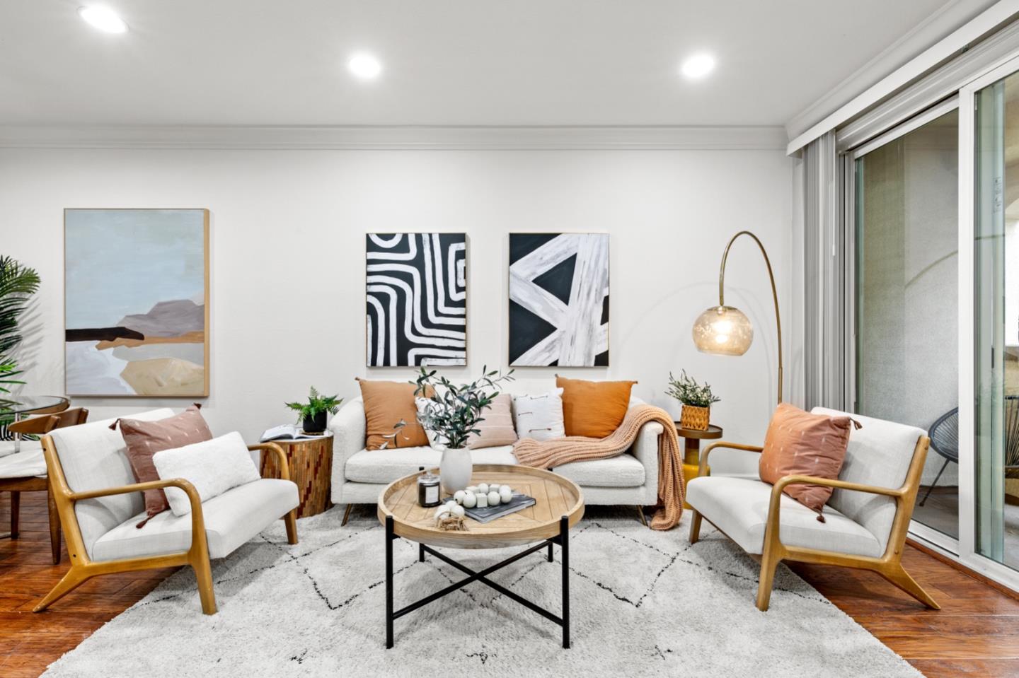 a living room with furniture and wooden floor