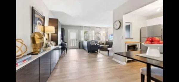 a hallway with a large window and furniture