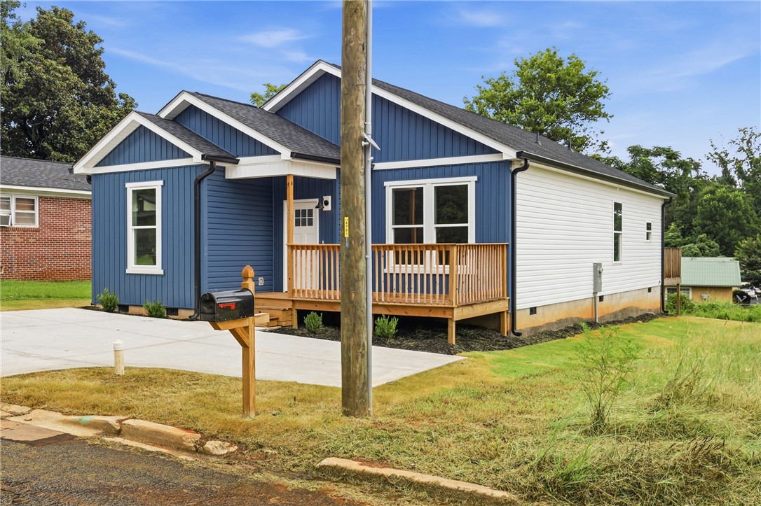 403 Tribble Street Seneca, SC 29678 - Photo 29 of 37 A charming blue and white exterior with a welcoming wooden porch creates inviting curb appeal.