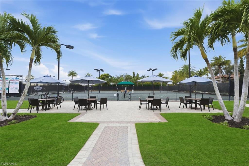 9365 Pocida Court, Unit 202 Naples, FL 34119 - Photo 35 of 40 a view of a swimming pool and lounge chairs