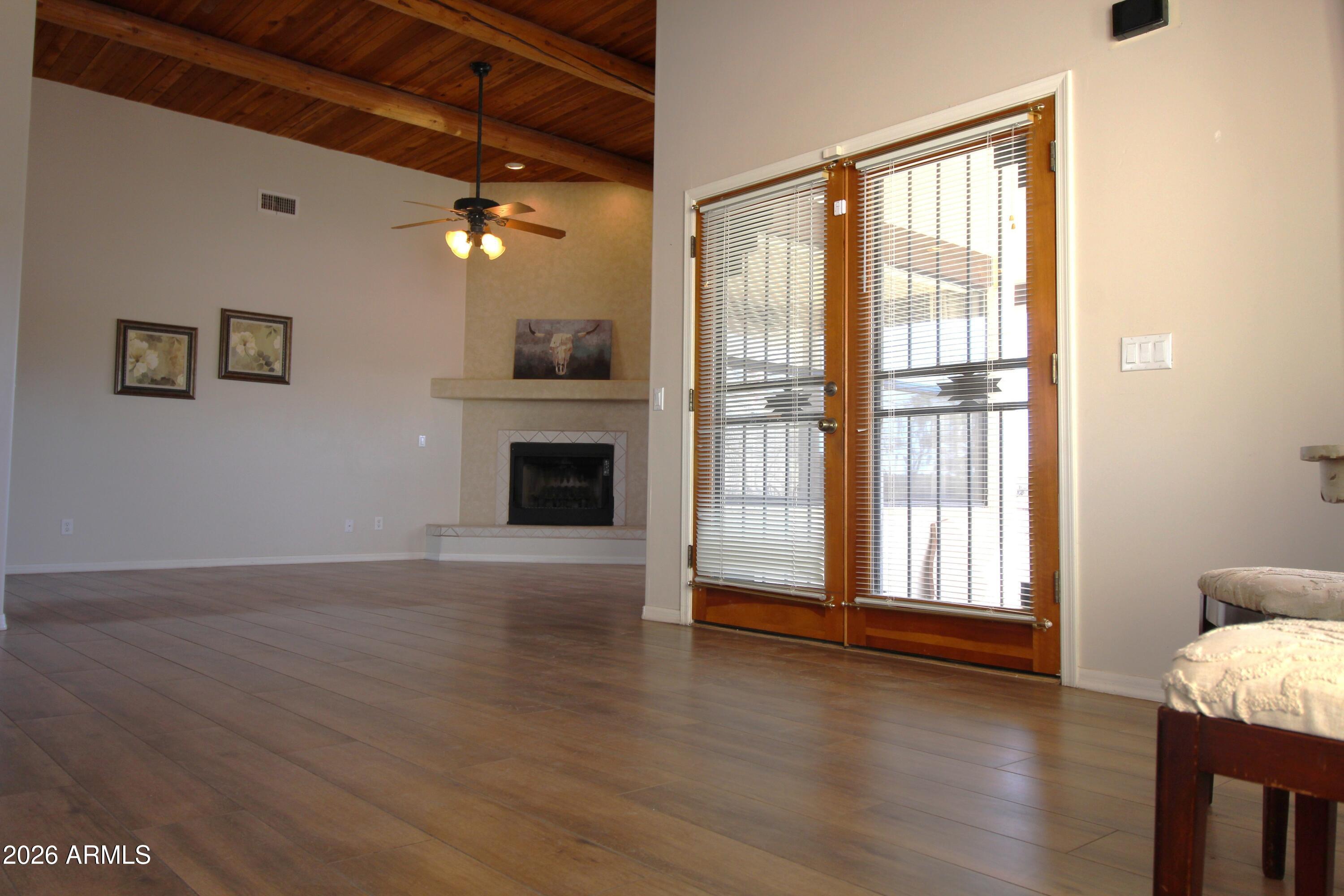 1405 East Circle Mountain Road New River, AZ 85087 - Photo 17 of 40 a view of a livingroom with wooden floor and a fireplace