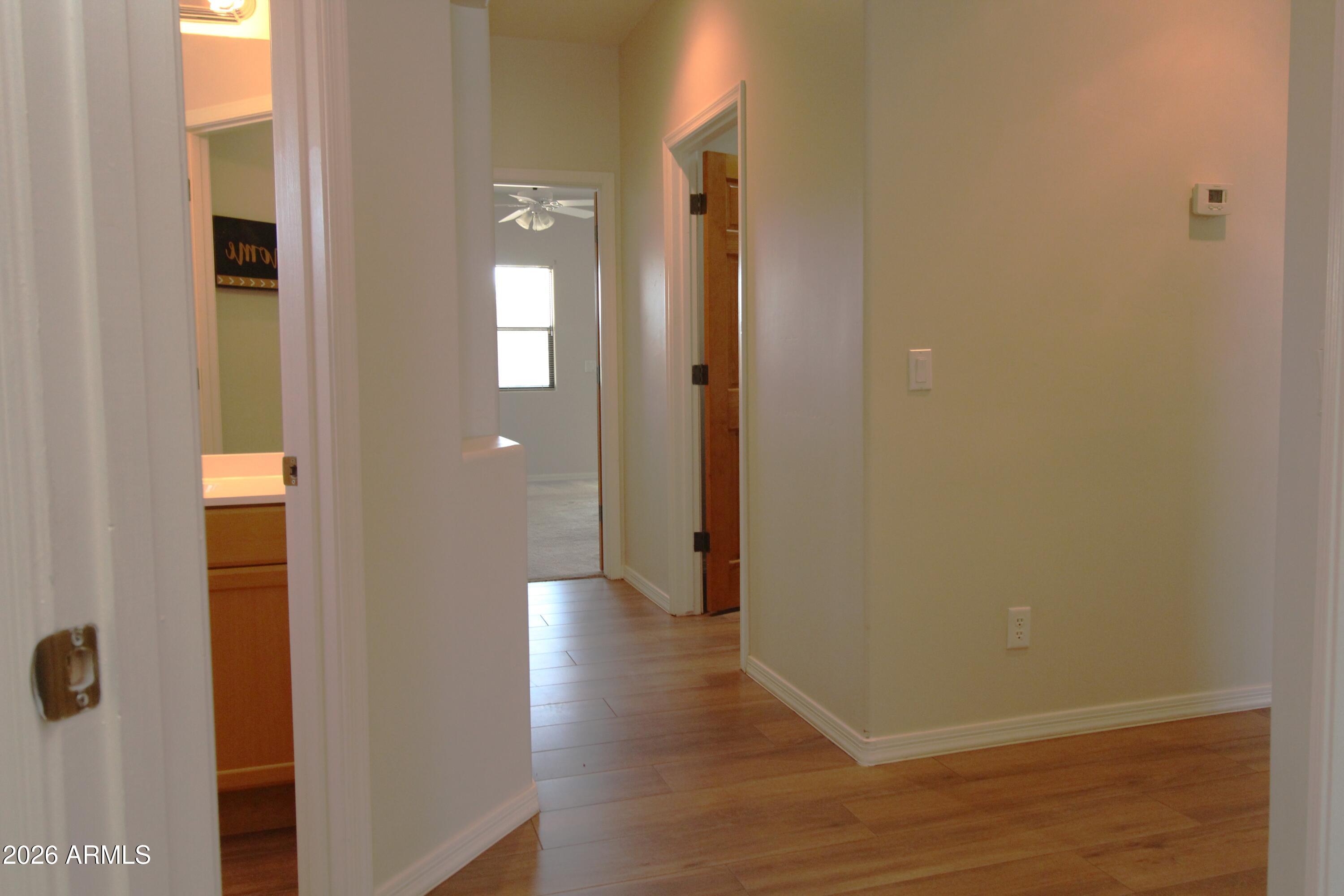 1405 East Circle Mountain Road New River, AZ 85087 - Photo 20 of 40 a view of a hallway with wooden floor