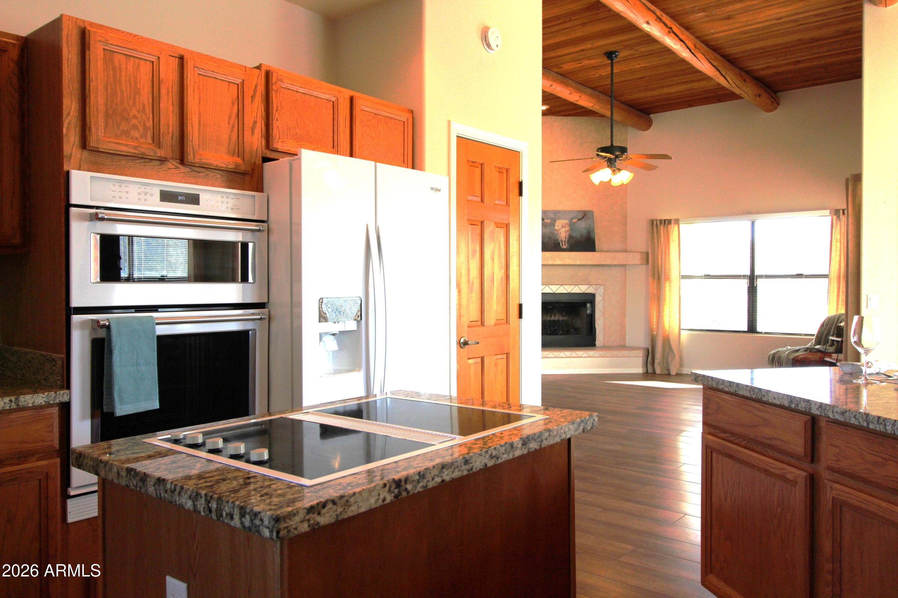 1405 East Circle Mountain Road New River, AZ 85087 - Photo 2 of 40 a kitchen with granite countertop a sink and a refrigerator