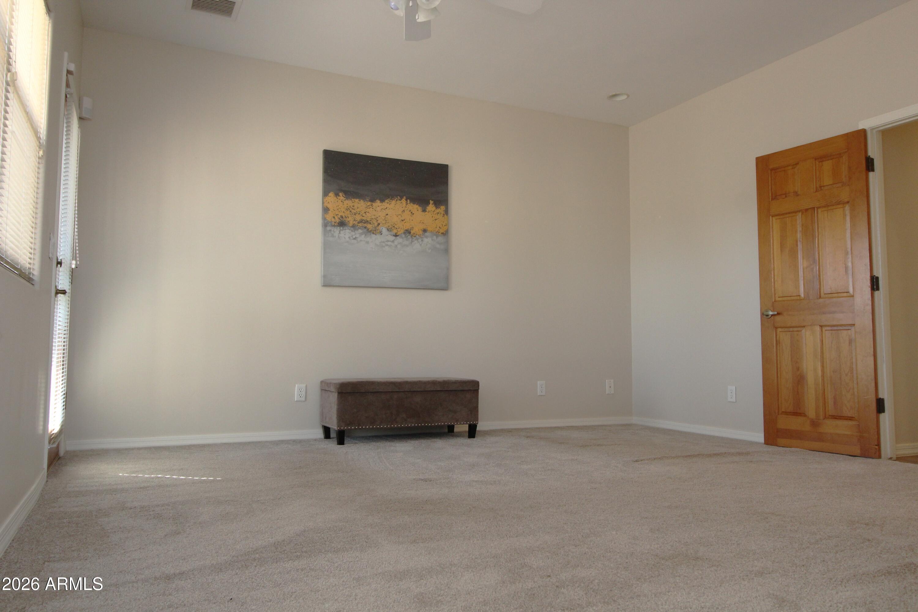 1405 East Circle Mountain Road New River, AZ 85087 - Photo 21 of 40 a view of a livingroom with an empty space and a window
