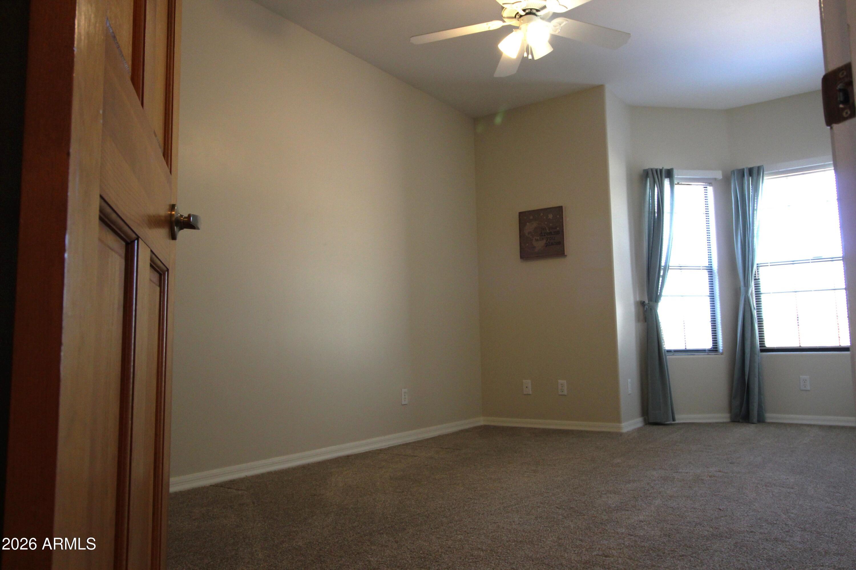 1405 East Circle Mountain Road New River, AZ 85087 - Photo 25 of 40 an empty room with windows and fan